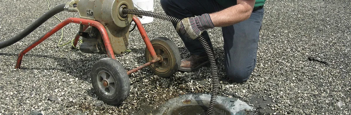 sewer rodding technician actively removing blockages from a sewer line in Boston, MA