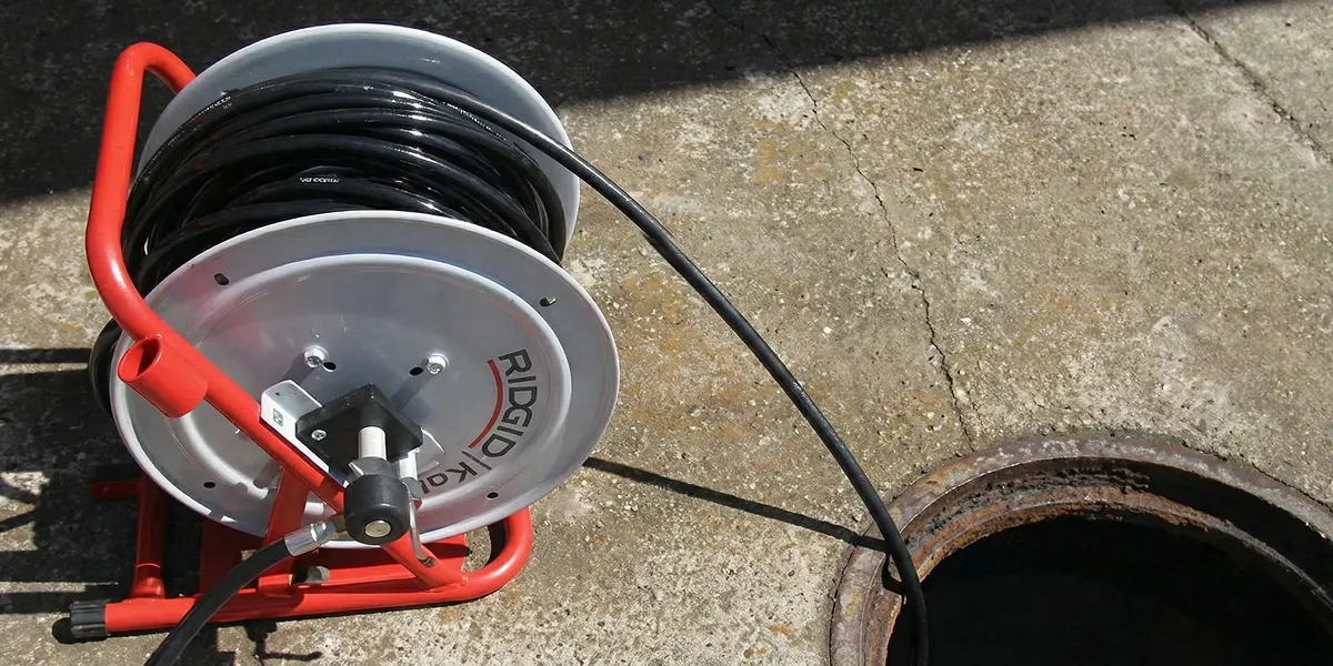 sewer rodding equipment prepared to clear clogged sewer lines in Boston, MA